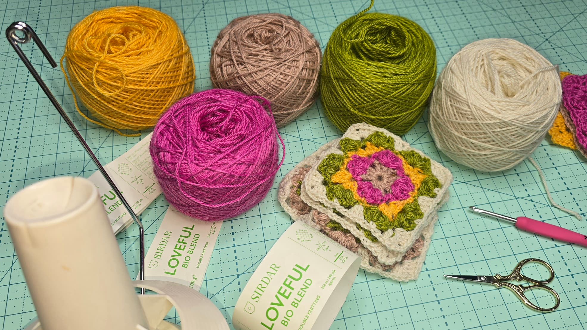 Rewinded yarns on the desk with granny squares