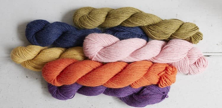 a bunch of Debbie Bliss Aymara yarn in color variations